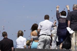 Throwing rose petals into the water